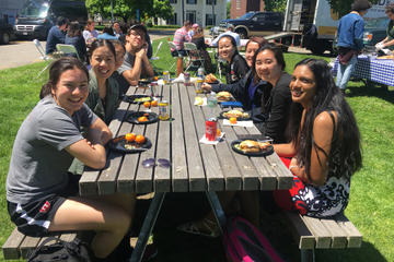 undergrads sitting at picnic table
