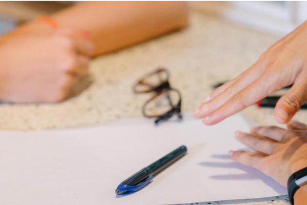 two women talking about paperwork