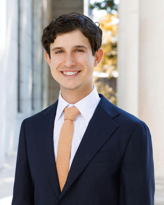 Dominic Russell headshot photo in front of Littauer Center